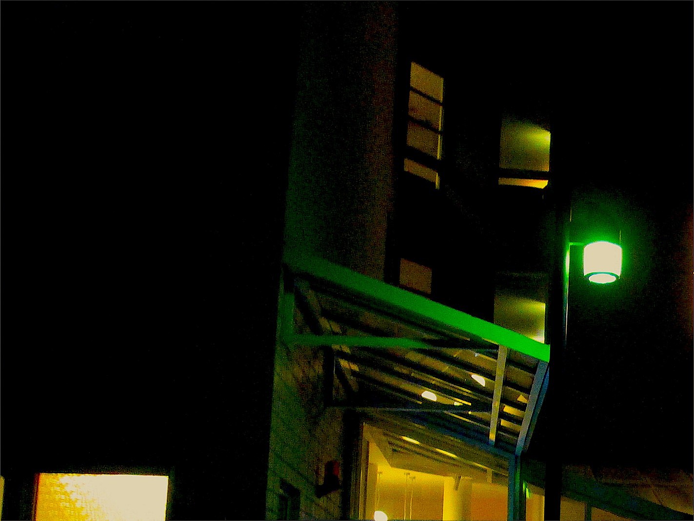 Night Modern House Building Warm Window Lightings with a Green Porch Light